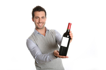 Happy winegrower showing wine bottle to camera