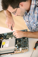 Man fixing electronic appliance