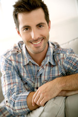 Portrait of handsome guy relaxing at home