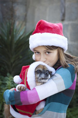 Girl and dog in santa hats