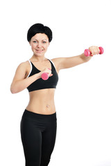 Fototapeta na wymiar Portrait of young fitness woman with a dumbbells