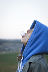 Girl blowing chewing gum bubble