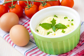 Whipped steam eggs in a cup with green onions for breakfast