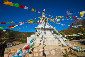 buddhist stupa and prayer flags