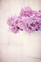 Bouquet of purple lilac flowers on vintage background