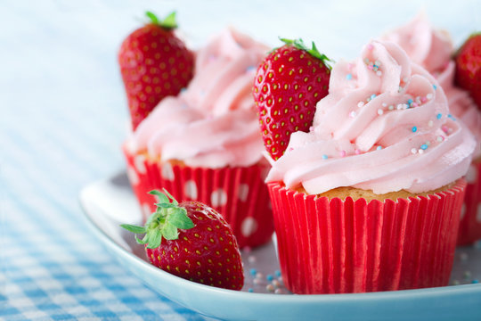 Cupcakes with strawberries and colorful sprinkles