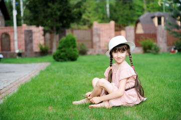 Amazing little girl in pink dress and white hat