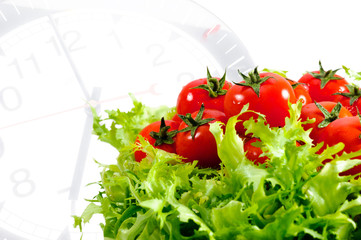 salad with fresh  tomatoes isolated on clock's  background