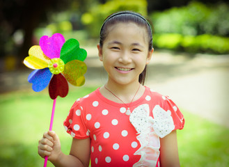 little girl playing pinwheel