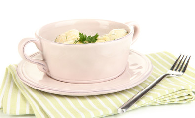 Tender young potatoes with sour cream and herbs in pan isolated