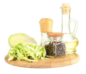 Green cabbage, oil, spices on cutting board, isolated on white
