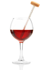 Glass of wine with thermometer, isolated on white