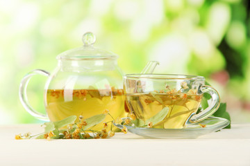 Kettle and cup of tea with linden