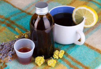 Cough syrup on knitted scarf close-up