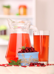 Pitcher and glass of cranberry juice with red cranberries