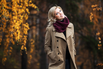 Young blond woman in autumn forest