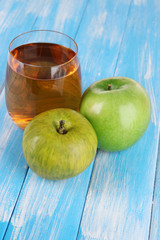 Glass of fresh apple juice on table close-up