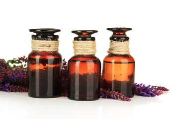 Medicine bottles and salvia flowers, isolated on white