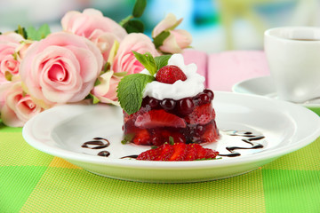 Tasty jelly dessert with fresh berries, on bright background