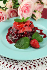 Tasty jelly dessert with fresh berries, on pink roses