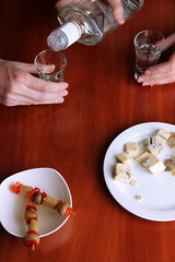 Drunk mans drinks vodka at table close-up