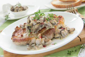 Pork steak with mushroom sauce and cream.