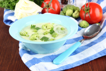 Cabbage soup in plates on napkin on wooden table