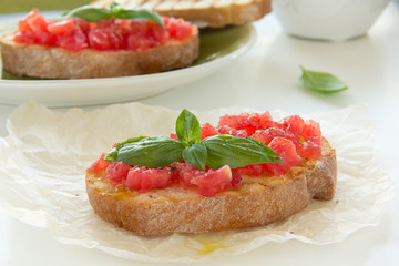 Bruschetta with tomato, basil and olive oil.