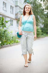   pregnant woman walking on street