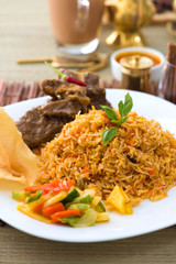 Mutton Biryani rice with traditional items on background