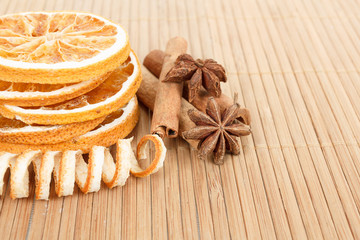 Star Anise, cinnamon and dried orange wooden background
