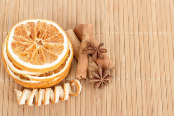 Star Anise, cinnamon and dried orange wooden background