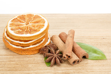Star Anise, cinnamon and dried orange wooden background