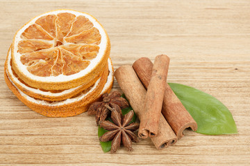 Star Anise, cinnamon and dried orange wooden background