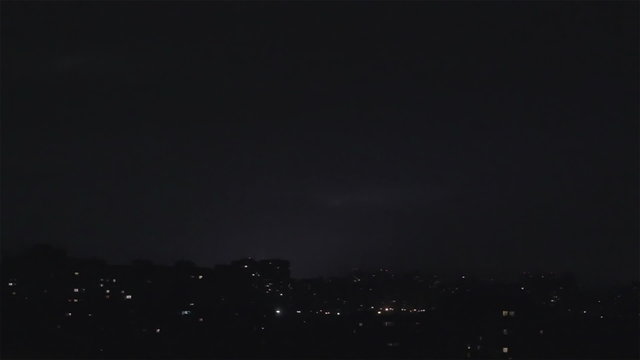 Lightning strikes buildings in city sky. Thunder sound roars