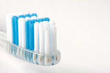 Close up of a blue and white toothbrush