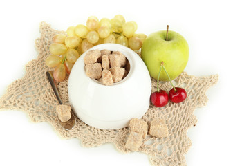Unrefined sugar in white sugar bowl on grey background