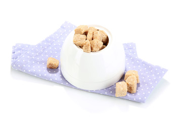 Unrefined sugar in white sugar bowl on white background