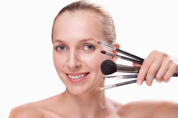 Woman with makeup brushes isolated