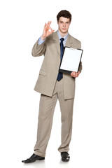 Businessman holding blank whiteboard showing OK gesture