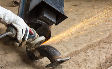 Metal industry worker grinding