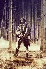 A male bow hunter wearing gas mask