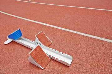 Closeup starting blocks on red race track