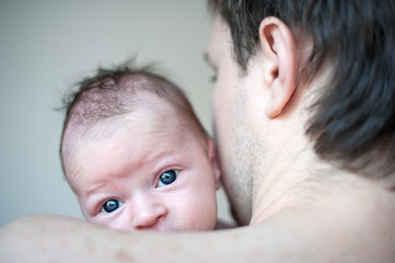 Happy young father with little baby