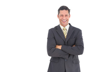 Laughing businessman with crossed arms