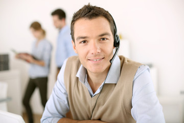 Portrait of consultant on the phone with headset
