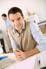 Portrait of smiling man sitting in office
