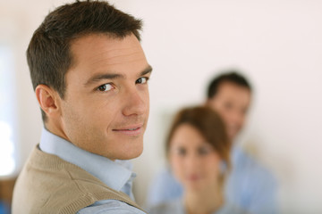 Handsome man standing in front of business team