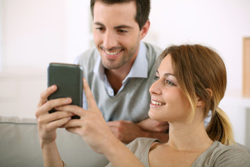 Young people at home using smartphone