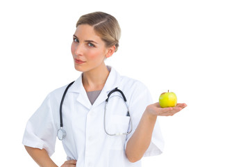 Nurse holding green apple